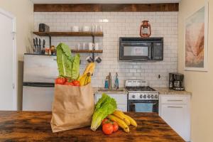 a bag of vegetables sitting on a table in a kitchen at King Bed Sleeps 3 2 Beds Walkable Cozy in Philadelphia