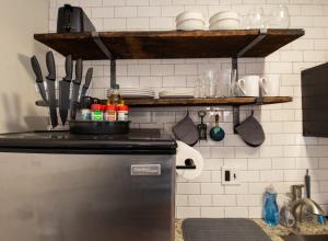 a kitchen with a refrigerator and a shelf with utensils at King Bed Sleeps 3 2 Beds Walkable Cozy in Philadelphia