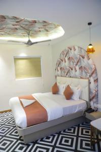 a bedroom with a bed with a large headboard at Ashray Guest House in Kalyan