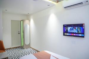 a room with a flat screen tv on a wall at Ashray Guest House in Kalyan
