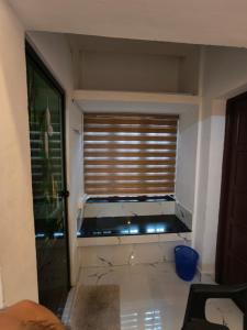 a large aquarium in a room with a window at Ram's Heaven in Guruvāyūr +15 photos