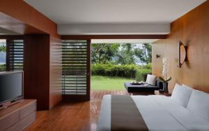 a bedroom with a large bed and a television at The Lalu Sun Moon Lake in Yuchi
