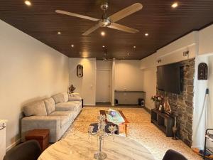 a living room with a couch and a table at The Hideaway in Sydenham