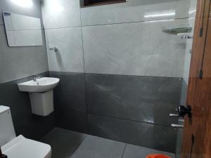 a bathroom with a toilet and a sink at Ocean wings Traditional beach villa in Kaipamangalam +12 photos