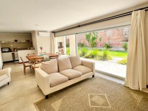 a living room with a couch and a large window at Departamento PIPE in Bella Vista
