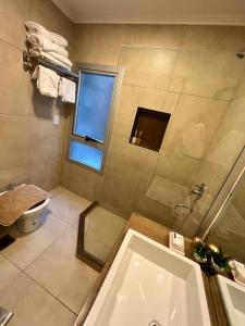 a bathroom with a shower and a tub and a toilet at Departamento PIPE in Bella Vista