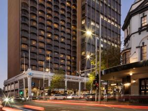 a city street with cars in front of a building at The Sydney Boulevard Hotel in Sydney