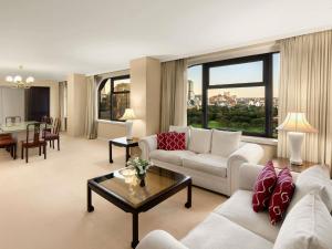 a living room with a couch and a table at The Sydney Boulevard Hotel in Sydney