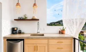 a kitchen with a sink and a window at Sayulita Boutique Suites - Pool Access, Kitchen, Walk to Beach in Sayulita