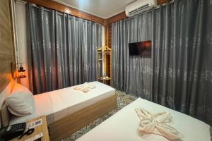 a bedroom with a bed and a tv and curtains at Rue DeuxVilles Villa in Loon +33 photos