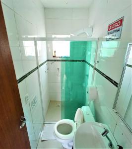 a bathroom with a shower and a toilet and a sink at Sea Wolf Surf Hostel in Florianópolis +74 photos