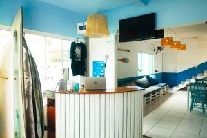 a room with a counter with a laptop on it at Sea Wolf Surf Hostel in Florianópolis