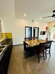 a kitchen with a dining room table and chairs at LAA Maison in Hoi An