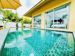 a swimming pool next to a house at LAA Maison in Hoi An