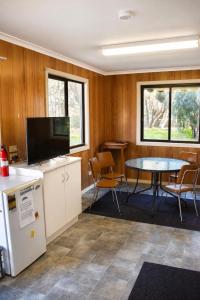 a conference room with a table and a tv at Warrack Motel in Warracknabeal
