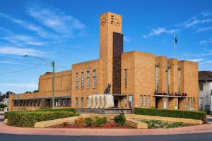 a brick building with a statue in front of it at Warrack Motel in Warracknabeal