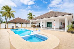 a villa with a swimming pool and a house at D2 Private Pool Villa Snooker Family & Friends in Hua Hin
