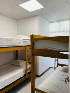 a dorm room with three bunk beds in it at Corazón garden in Piura +13 photos