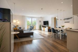 a living room and kitchen with a couch and a table at Wohnart - Fewo 1 Wohnstil in Norderney
