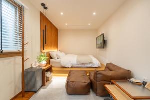 a living room with a bed and a couch at Nakwon Stay 3-Min Walk to Anguk & Jongno 3-ga Stations in Seoul