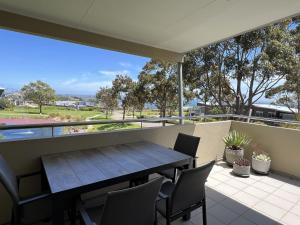 a table and chairs on the balcony of a house at Sanny Side Up in San Remo