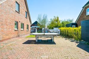 a picnic table sitting on a brick patio at Ferienwohnung Luv Dagebüll in Dagebüll