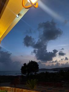 a view of a cloudy sky with a ceiling fan at Sukhavasam Beach Resort in Adgaon