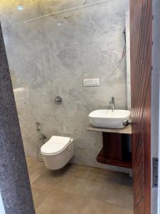 a bathroom with a toilet and a sink at Sukhavasam Beach Resort in Adgaon