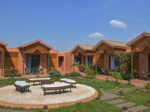 a group of houses with picnic tables in the yard at NOVOTEL KOLWEZI in Kolwezi