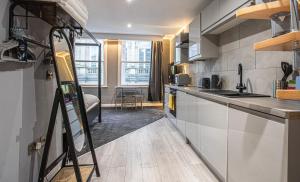 a room with a kitchen with a counter top and a kitchen at The Piece Hall Harmony Designer Studio - Superking in Halifax +2 photos