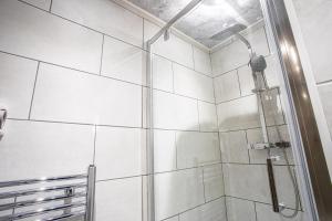 a shower with a glass door in a bathroom at The Piece Hall Harmony Designer Studio - Superking in Halifax
