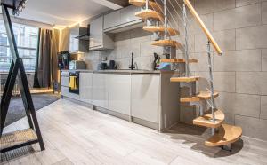 a kitchen with a spiral staircase in a room at The Piece Hall Harmony Designer Studio - Superking in Halifax