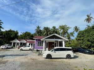 a white car parked in front of a house at Ar Homestay Merlimau in Merlimau