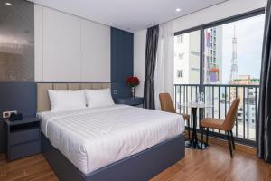a bedroom with a bed and a balcony at Amora Hotel in Nha Trang +32 photos