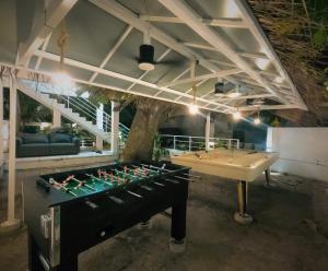 a room with a pool table and a ping pong ball at Oceana Surf Maldives - Kudahuvadhoo Island Surf Retreat in Kudahuvadhoo