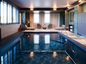 a large swimming pool in a hotel room at Mercure Quimper Kerlic in Quimper