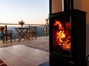 a fireplace in a room with a view of a table at Mantis Hiddn in Addo in Addo