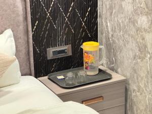a tray with a coffee maker on a night stand next to a bed at Hotel Maheshwari Tehri in Tehri-Garhwāl +201 photos