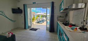 a kitchen with an open door leading to a patio at Abiki Mauritius with Tourism Authority Permit in Albion