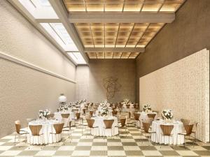 a banquet hall with white tables and chairs at Novotel St Kilda in Melbourne +10 photos