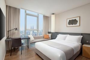 a hotel room with a large bed and a couch at Shilla Stay Gangnam Yeoksam in Seoul