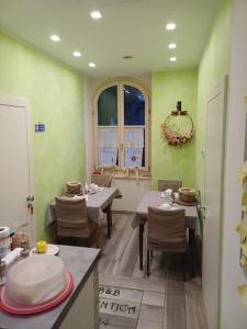 a dining room with two tables and a window at Ca' antica B&B in Rovereto