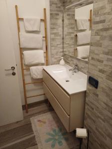 a bathroom with a sink and a mirror and towels at Ca' antica B&B in Rovereto