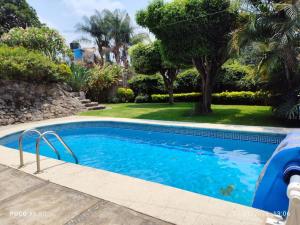 a swimming pool in a yard with trees at Quinta Huicochea in Cuernavaca