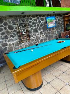 a pool table in front of a stone wall at Quinta Huicochea in Cuernavaca