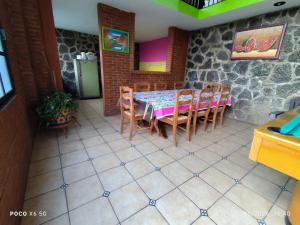 a dining room with a table and chairs in a house at Quinta Huicochea in Cuernavaca