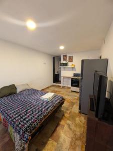 a bedroom with a bed and a tv in it at Nova Suites in San Juan Xilotzingo