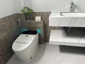a bathroom with a toilet and a sink at Bibo House - Near Xuan Huong Lake & Center in Da Lat