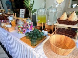 a table with glass jars and other items on it at Khota Hill Hotel in Nakhon Phanom