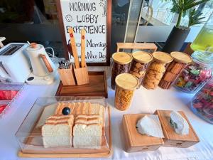 a table with bread and jars of food on it at Khota Hill Hotel in Nakhon Phanom +27 photos